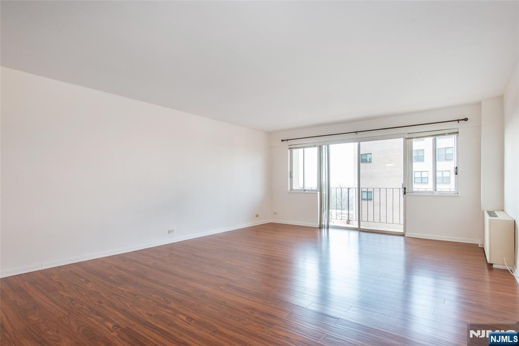 265 Main Street, Unit 503 Ridgefield Park, NJ 07660 - Photo 7 of 23 a view of an empty room with wooden floor and a window