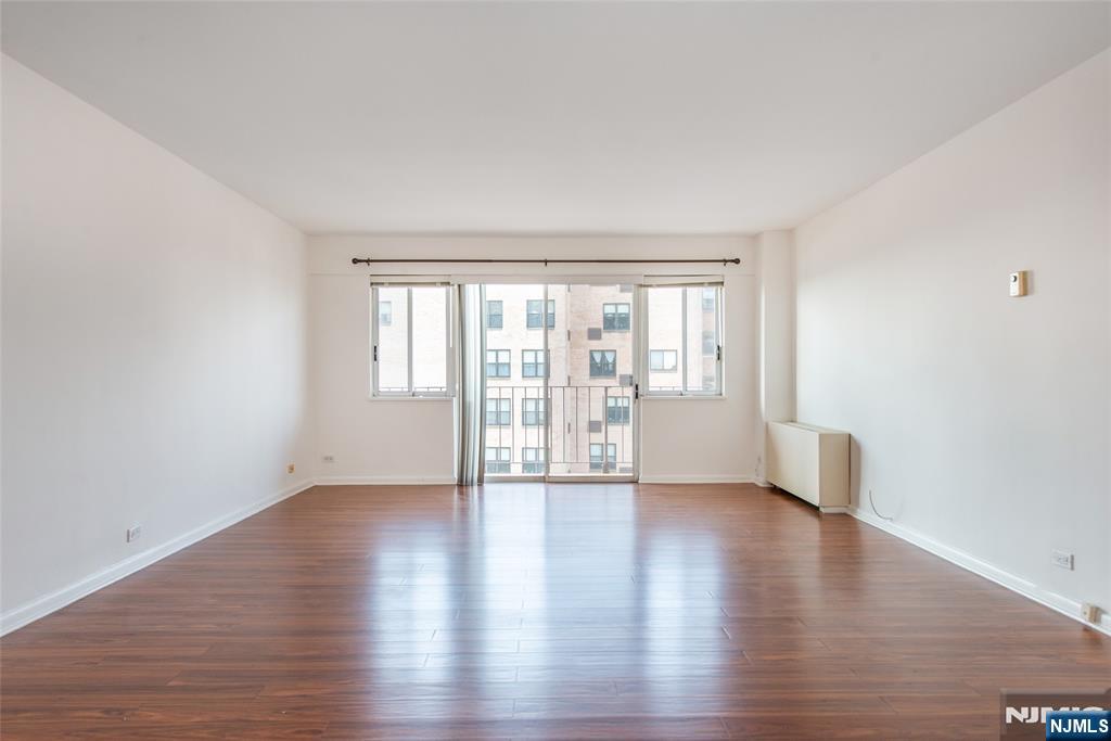 265 Main Street, Unit 503 Ridgefield Park, NJ 07660 - Photo 8 of 23 a view of an empty room with a window and wooden floor