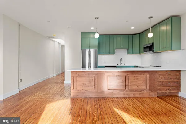 a view of kitchen with wooden floor