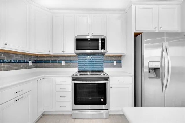 a bathroom with a granite countertop sink a mirror and a bathtub