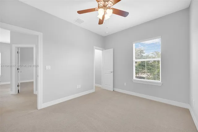 a front view of a house with a yard and green space