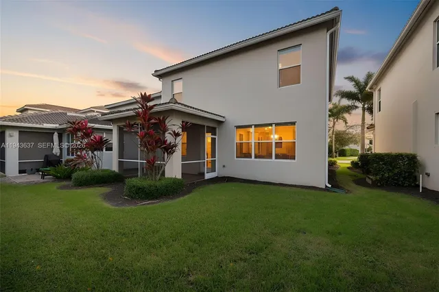 a living room with furniture potted plant and a large window