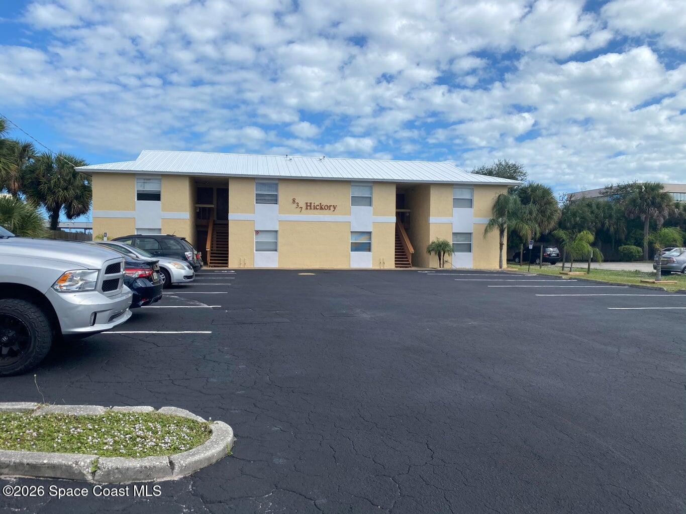 837 Hickory Street, Unit 3 Melbourne, FL 32901 - Photo 3 of 24 a view of a car park in front of a house