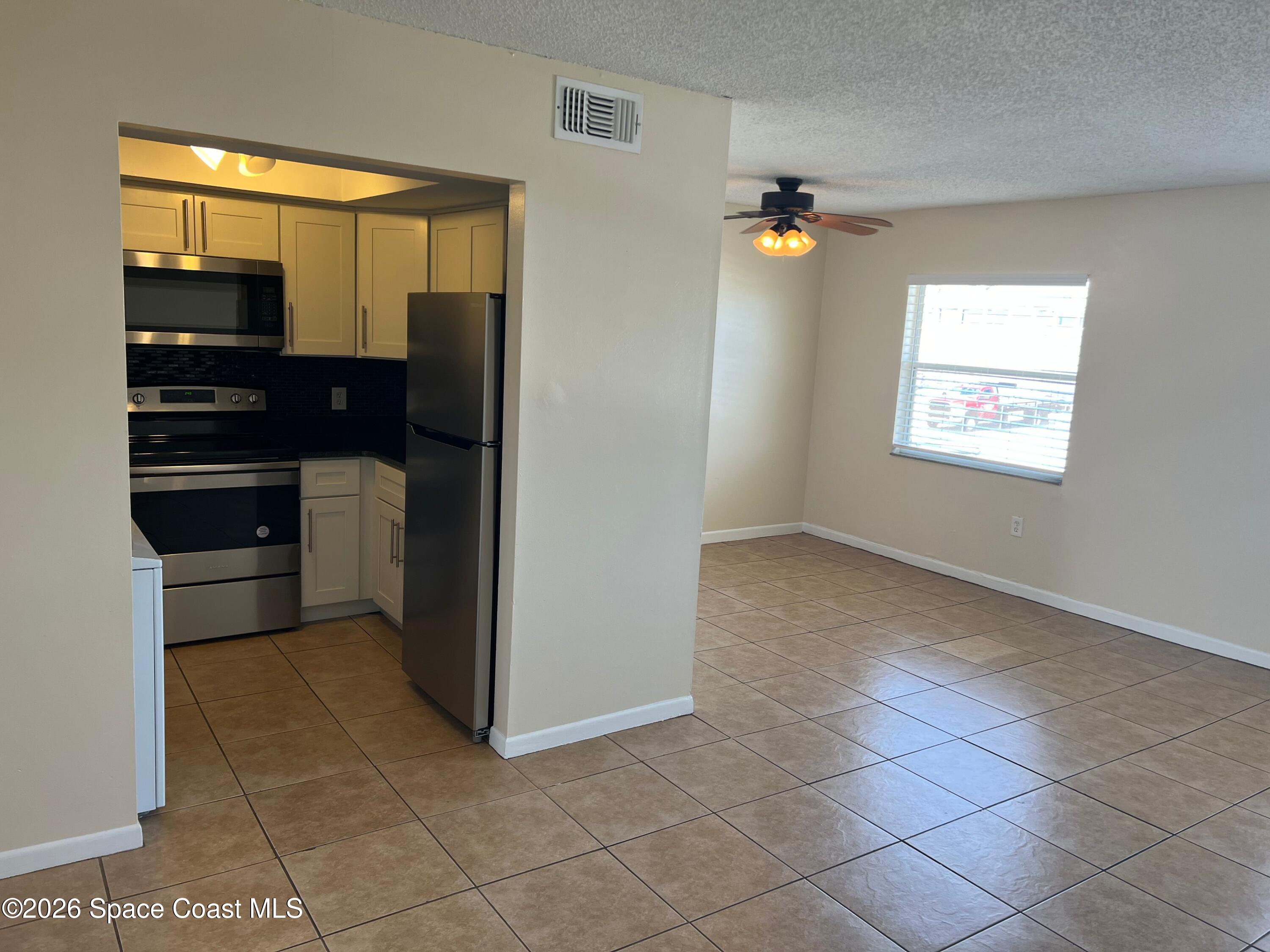 837 Hickory Street, Unit 3 Melbourne, FL 32901 - Photo 7 of 24 a view of a kitchen cabinets and refrigerator