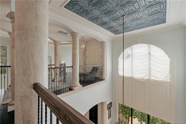 a living room with furniture fireplace and large windows