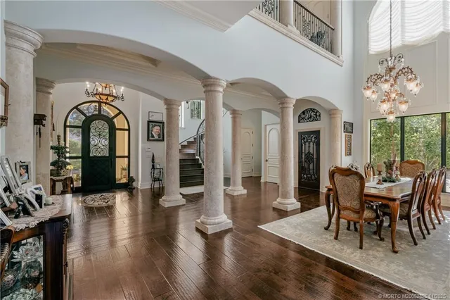 a view of a hallway with furniture and wooden floor
