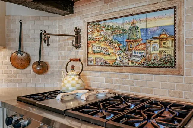 a living room with furniture a chandelier and a rug