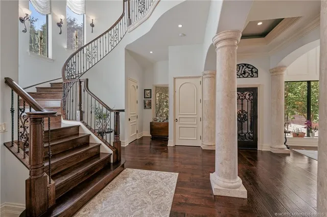 a dining room with furniture a potted plant and a chandelier