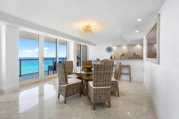 a kitchen with refrigerator and chairs