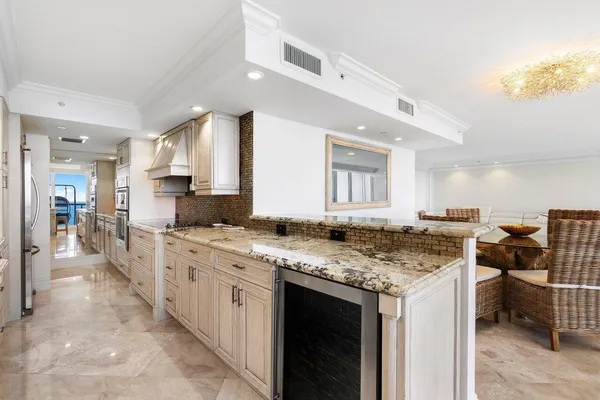 a kitchen with cabinets appliances a sink and a counter top space