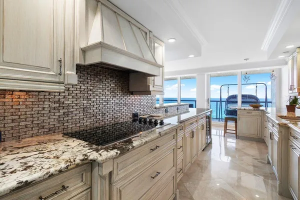 a bathroom with a granite countertop toilet sink and mirror