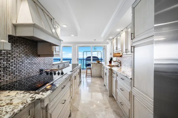 a bathroom with a granite countertop sink a toilet and shower