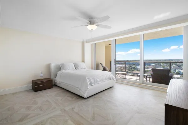 a bedroom with bed couches and flat tv screen
