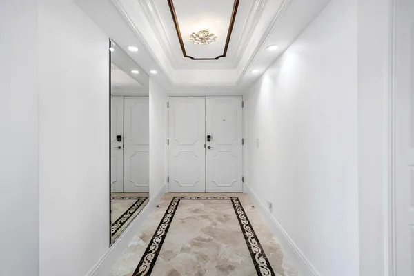 a view of a kitchen with kitchen island wooden floor and electronic appliances