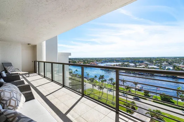 a bathroom with a granite countertop sink a toilet and a mirror