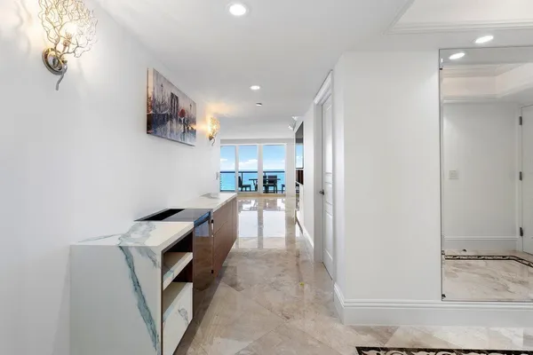 a living room with furniture and a lamp