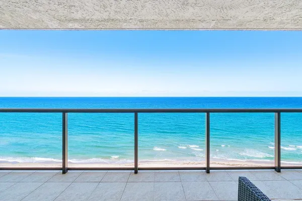a lobby with furniture and floor to ceiling window