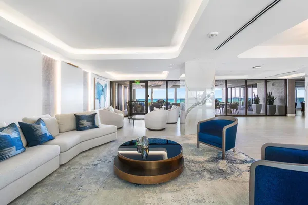 a front view of a building with glass windows and stairs