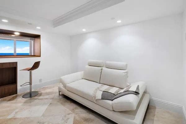 a living room with furniture and view of kitchen
