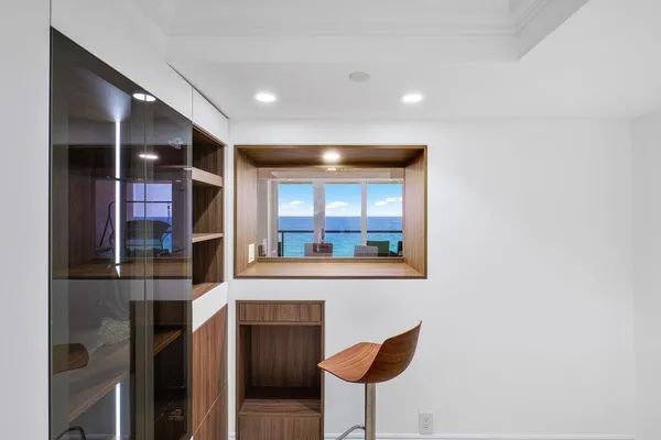 a lobby with furniture and large windows