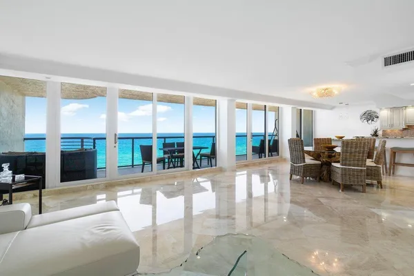 a dining room with furniture and a flat screen tv