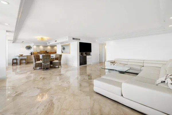 a dining room with furniture and a view of kitchen