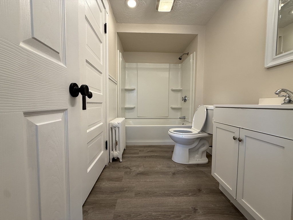 304 Lovell Street, Unit 2 Worcester, MA 01602 - Photo 13 of 13 a bathroom with a sink toilet and shower