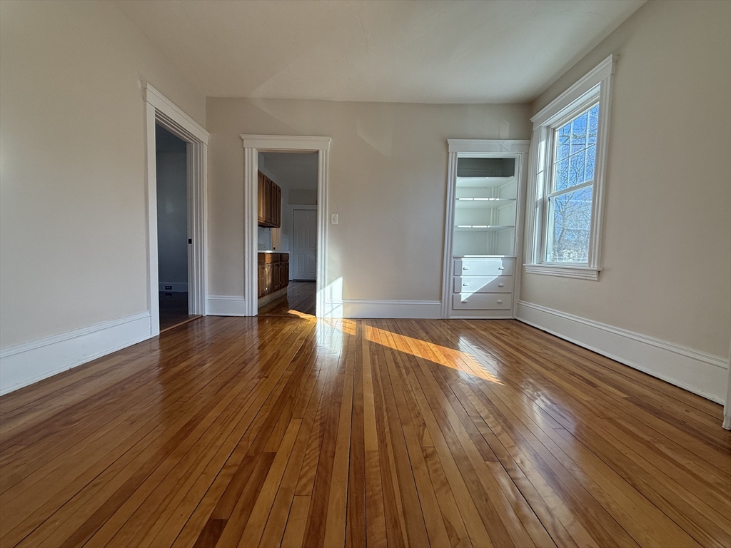 304 Lovell Street, Unit 2 Worcester, MA 01602 - Photo 3 of 13 a view of empty room with wooden floor and fan