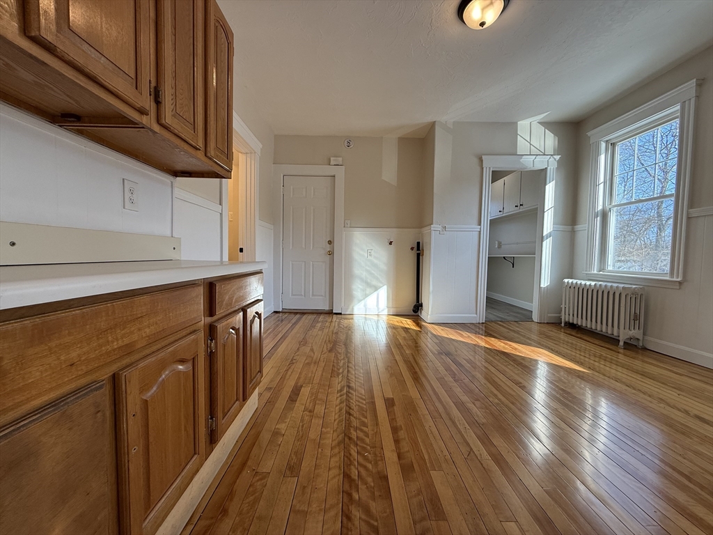 304 Lovell Street, Unit 2 Worcester, MA 01602 - Photo 10 of 13 a view of a kitchen with wooden floor and electronic appliances