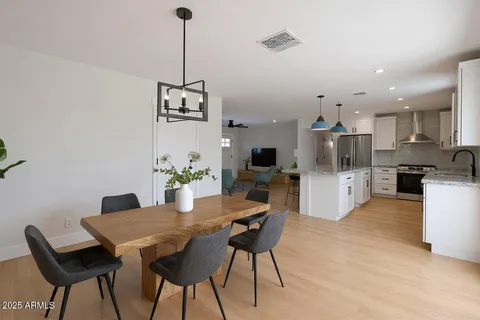 a view of a dining room with furniture and a chandelier