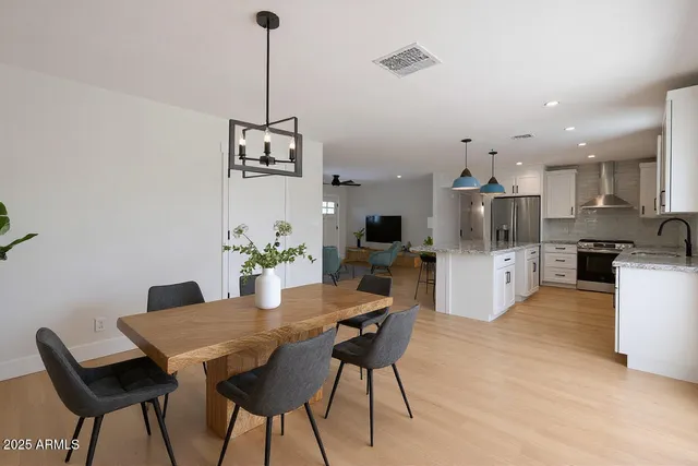 a view of a dining room with furniture and a chandelier