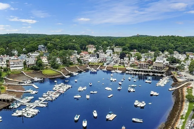 an aerial view of a house with parking space and lake view