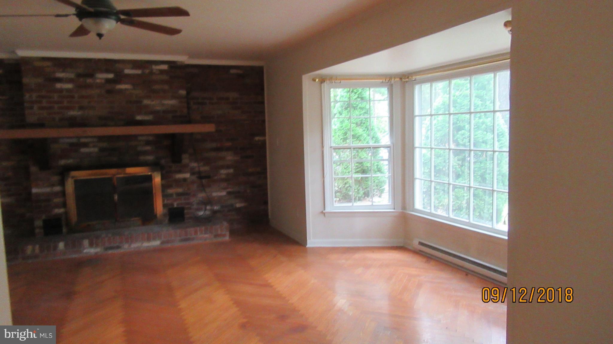 114 Woods Road Chester, MD 21619 - Photo 6 of 24 Hardwood Floors with Brick Fireplace