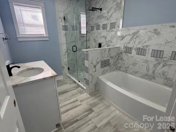 a bathroom with a bathtub and a sink