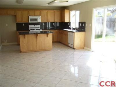 2255 Signal Avenue Santa Maria, CA 93458 - Photo 6 of 9 a kitchen with stainless steel appliances a sink a stove top oven a counter space and cabinets
