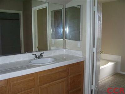 2255 Signal Avenue Santa Maria, CA 93458 - Photo 7 of 9 a bathroom with a granite countertop sink and a mirror