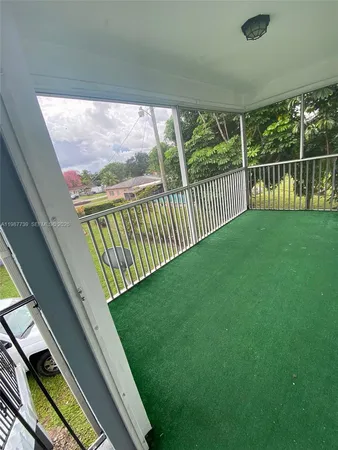 a view of balcony with yard