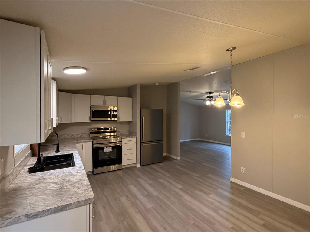 212 Paradise Shores Road Crescent City, FL 32112 - Photo 11 of 23 a kitchen with refrigerator and cabinets