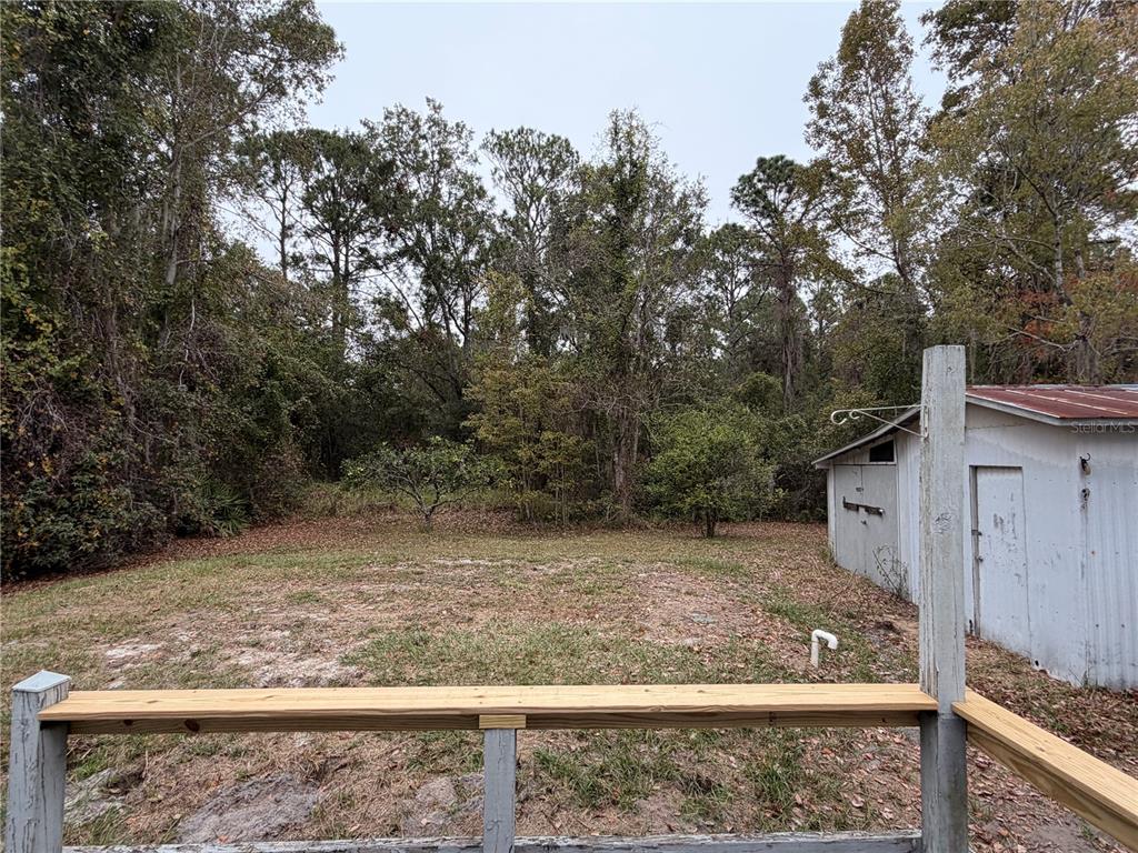 212 Paradise Shores Road Crescent City, FL 32112 - Photo 21 of 23 a view of a yard with wooden fence