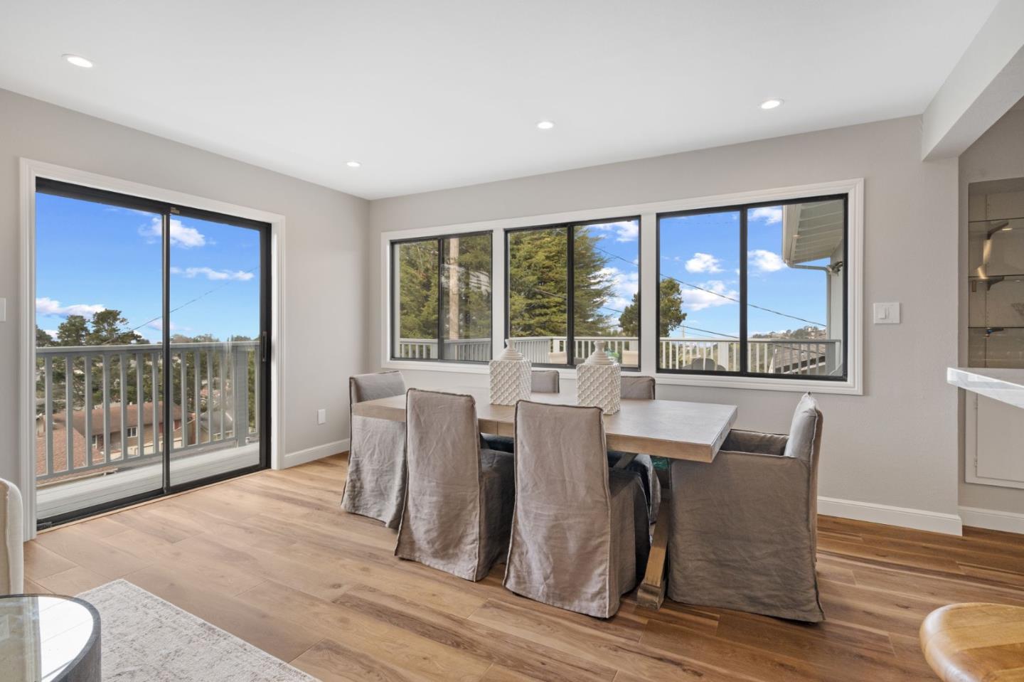 3901 Coronado Way San Bruno, CA 94066 - Photo 13 of 31 a view of a dining room with furniture large windows and wooden floor
