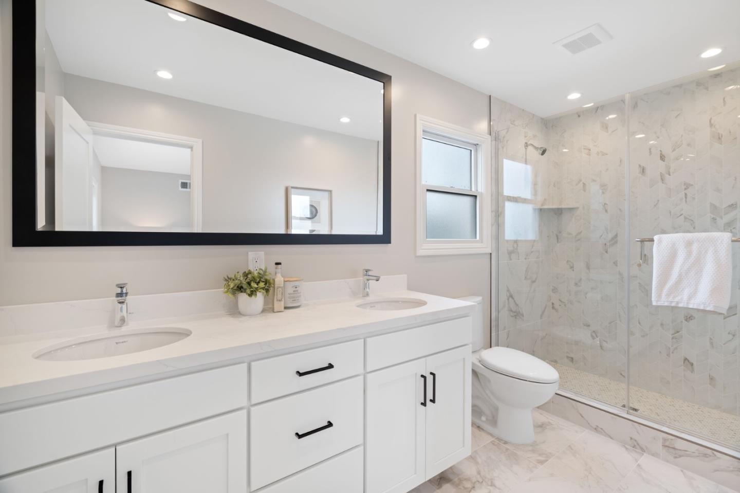 3901 Coronado Way San Bruno, CA 94066 - Photo 21 of 31 a bathroom with a toilet a sink a mirror and a shower