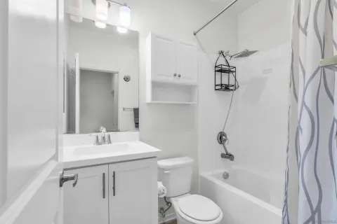 a bathroom with a sink toilet tub and shower