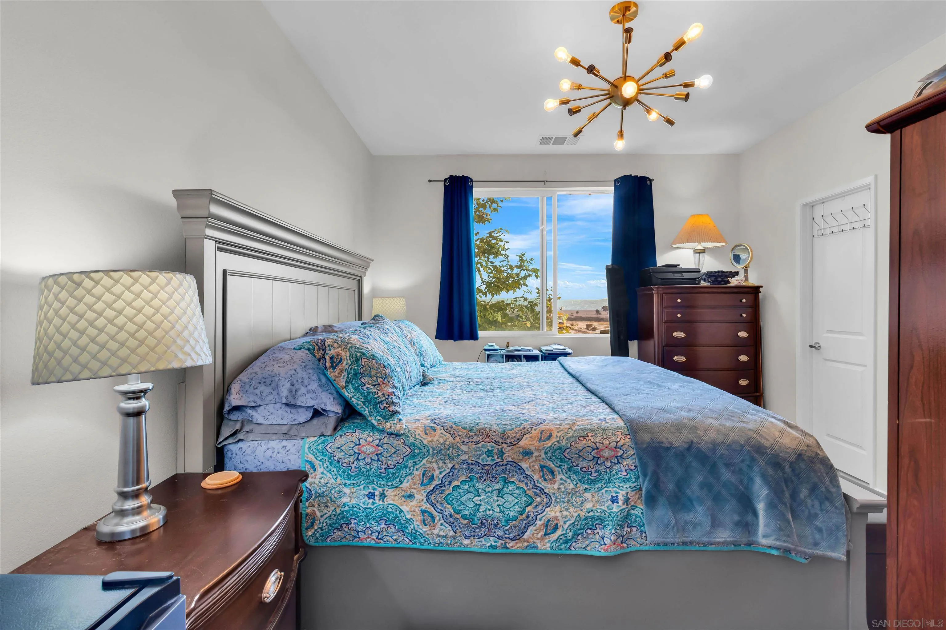 5515 San Roberto San Diego, CA 92154 - Photo 18 of 27 a bedroom with a bed and dresser with chair