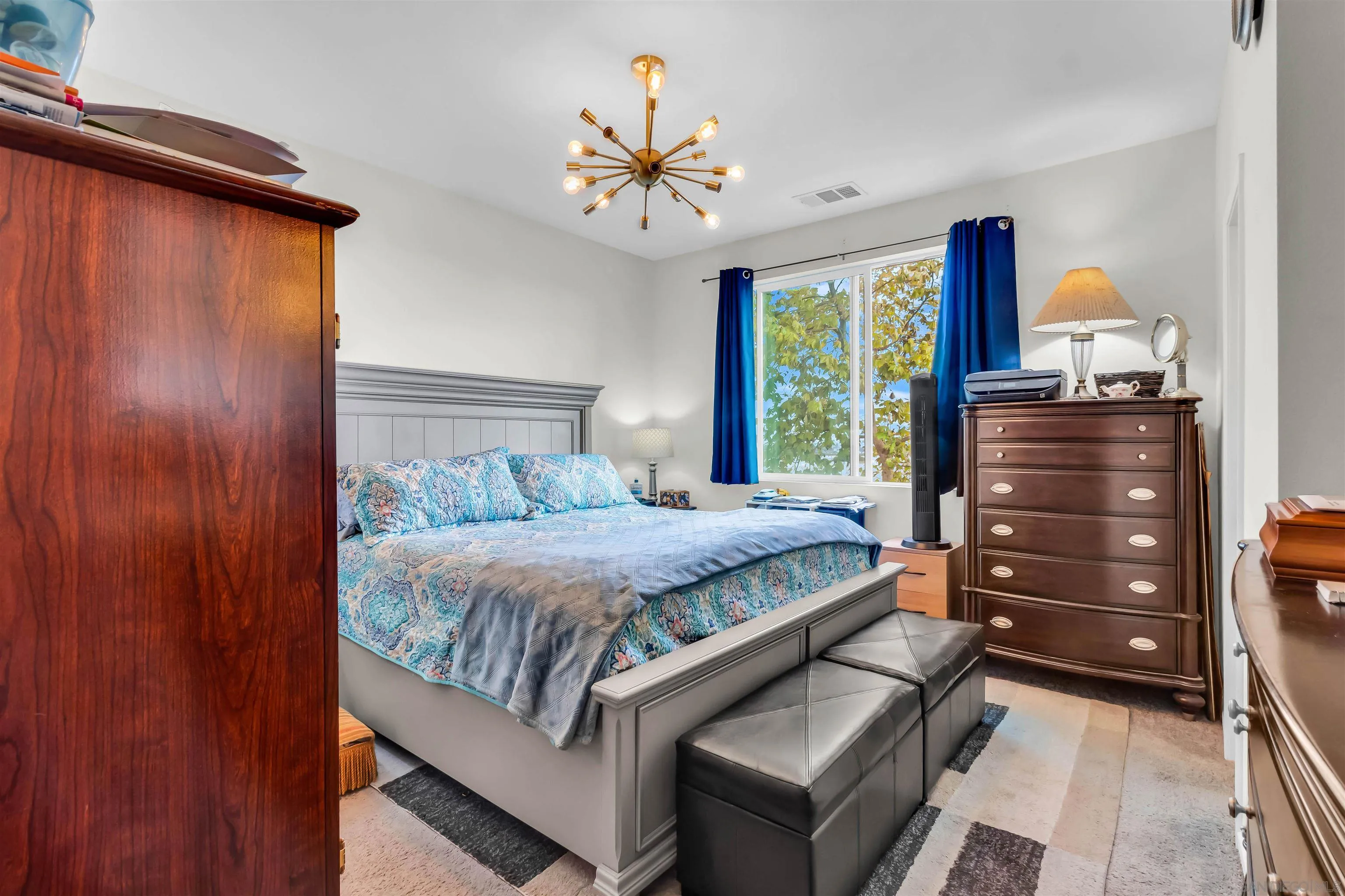 5515 San Roberto San Diego, CA 92154 - Photo 19 of 27 a bedroom with a bed and a chandelier