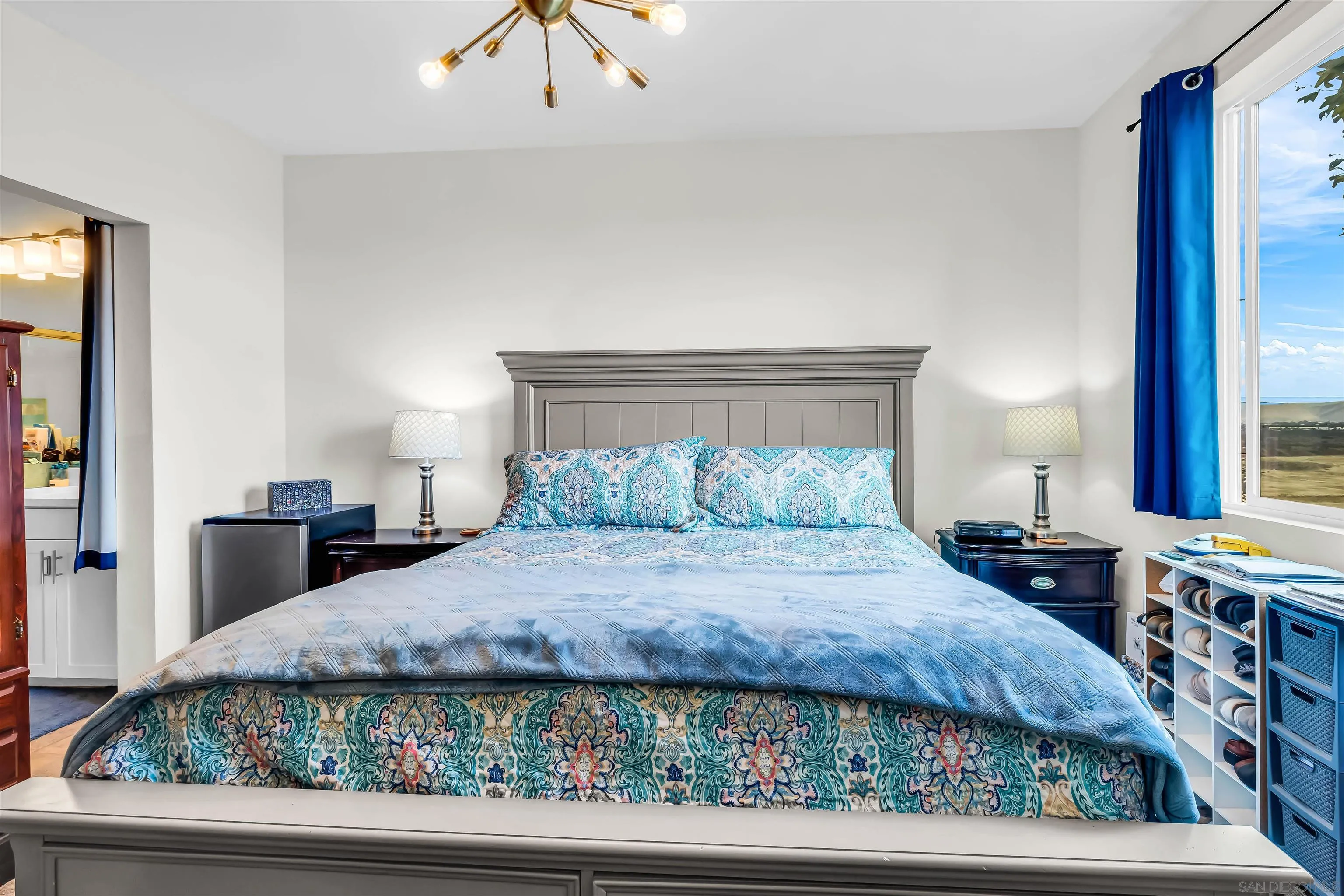 5515 San Roberto San Diego, CA 92154 - Photo 21 of 27 a bedroom with a large bed and a flat tv screen on dresser