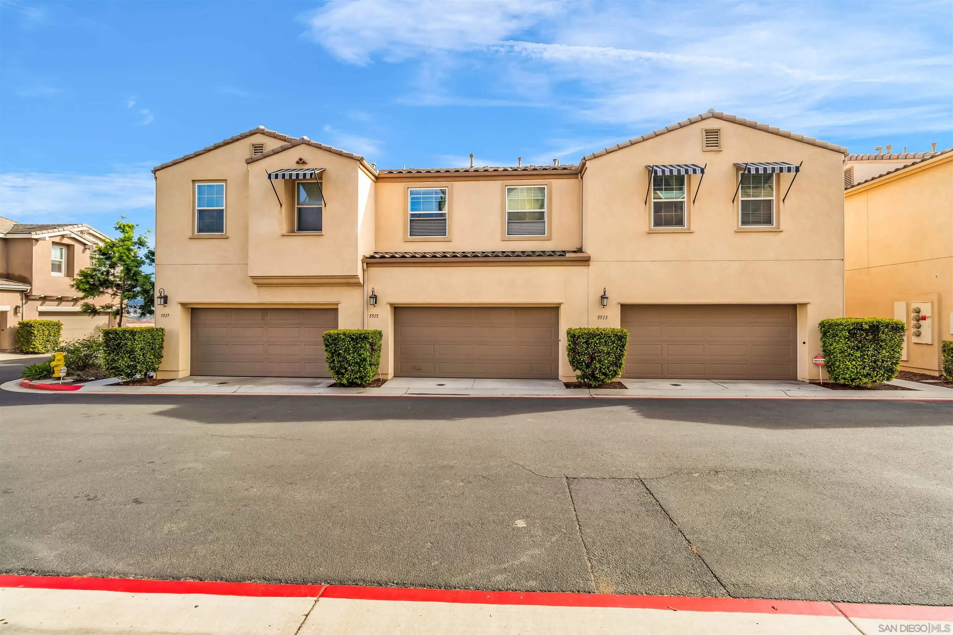 5515 San Roberto San Diego, CA 92154 - Photo 26 of 27 a front view of a house with a yard and garage