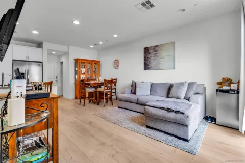 a living room with furniture and kitchen view
