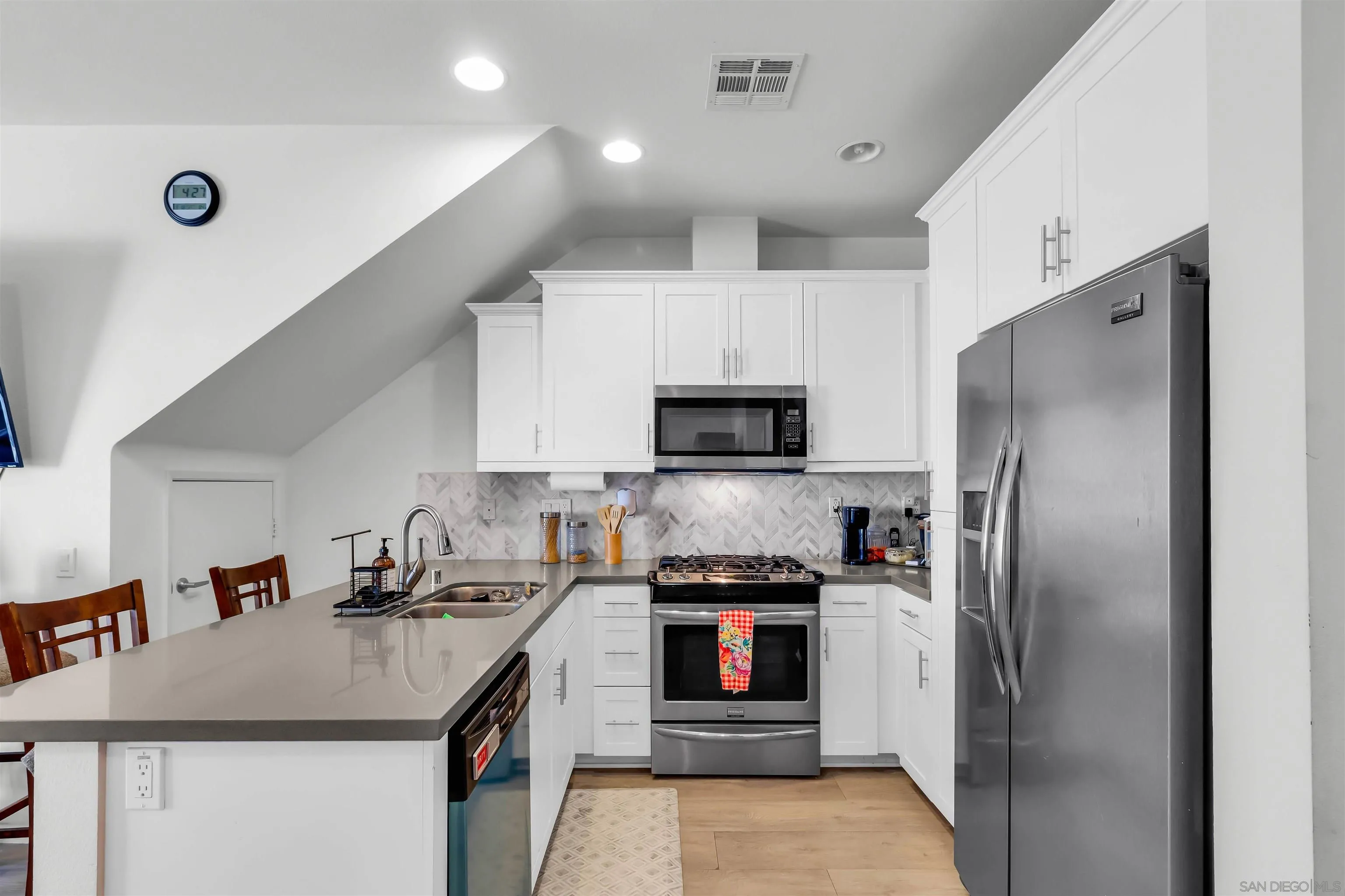 5515 San Roberto San Diego, CA 92154 - Photo 8 of 27 a kitchen with kitchen island a sink stainless steel appliances and cabinets