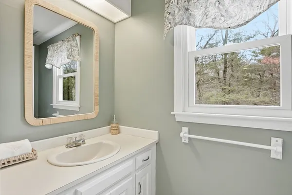 a bathroom with a sink and a window