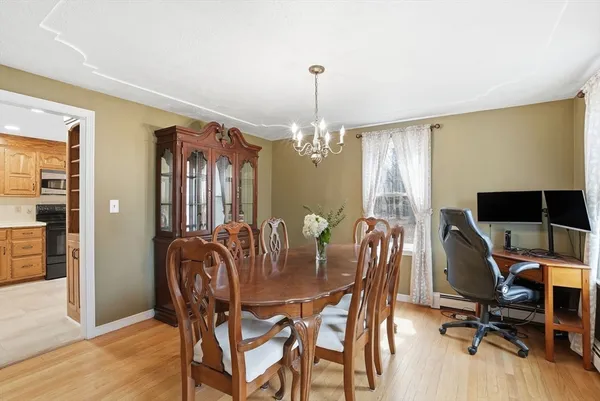 a view of a dining room with furniture and chandelier